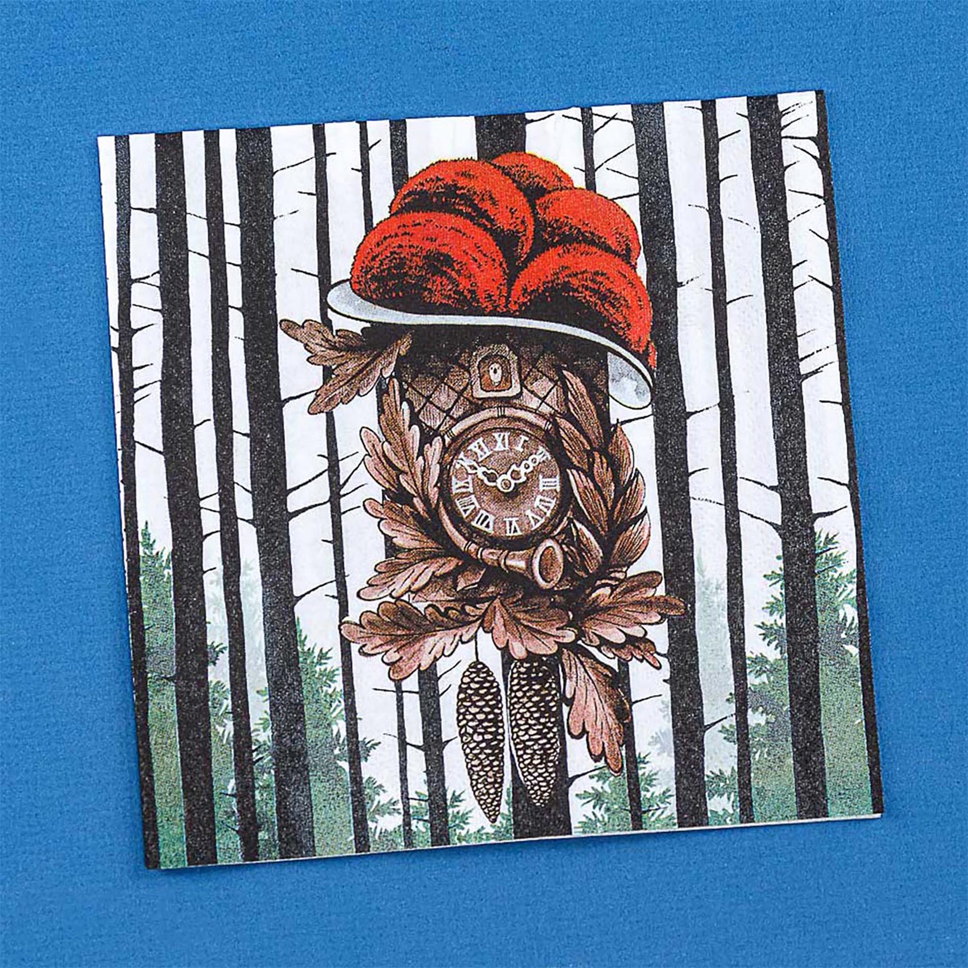 Schwarzwälder Kuckucksuhr mit rotem Bollenhut-Motiv im Tannenwald auf einer quadratischen Papierserviette.