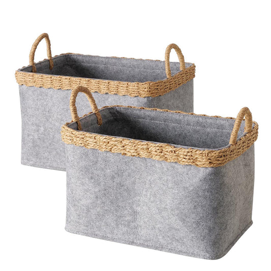 Freigestelltes 2-teiliges FeineHeimat Korbset Nilo – Zwei graue Filzkörbe in verschiedenen Größen mit dekorativem Rand aus Naturgeflecht und praktischen Tragegriffen.