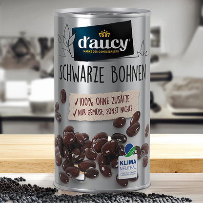 Dose ‚d’aucy Schwarze Bohnen‘ auf Holzoberfläche mit losen Bohnen – 100 % ohne Zusätze, klimaneutral produziert, rein pflanzlich